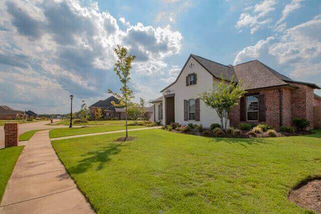 Beautiful suburban Ohio home with manicured landscaping, tree-lined sidewalk, and classic Midwest architecture — typical of Columbus, Cleveland, and Cincinnati suburbs